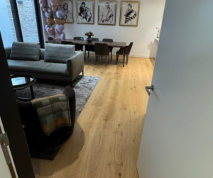 Open-plan living and dining area in a refurbished Notting Hill property featuring oak flooring and contemporary interior finishes