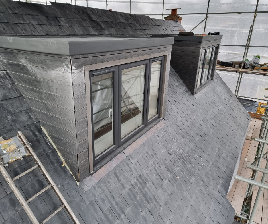 Dormer loft conversion with new windows and slate roof construction