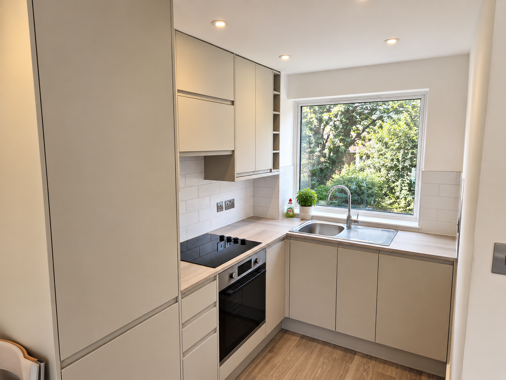 Modern fitted kitchen with integrated appliances and worktops