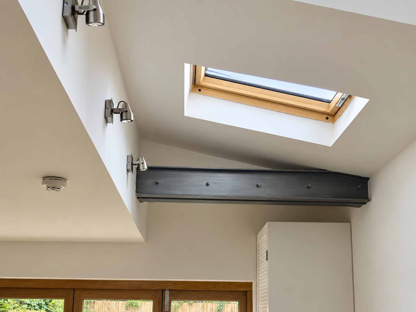 Completed extension interior with rooflight and exposed structural steel beam